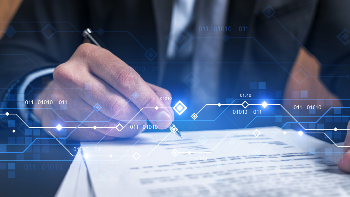 A Businessman Writes On Paper With A Pen, Set Against A Digital Background Filled With Abstract Patterns.